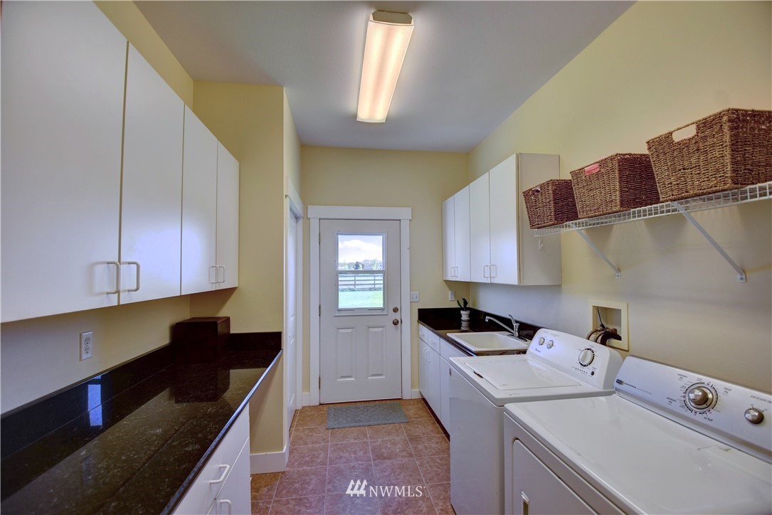 17012 Kaylen Lane Southwest Rochester, WA 98579 - Photo 7 of 26 a kitchen that has a sink and a stove in it