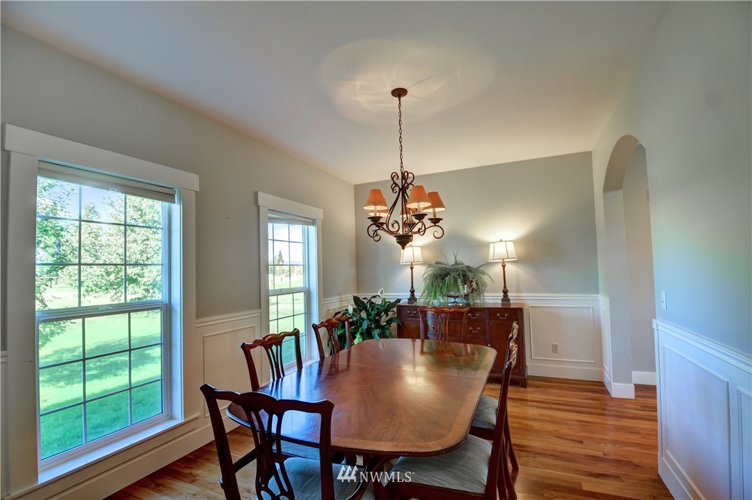 17012 Kaylen Lane Southwest Rochester, WA 98579 - Photo 8 of 26 a view of a dining room with furniture window and wooden floor