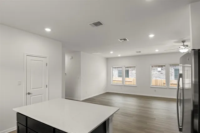 a view of a room with window and wooden floor
