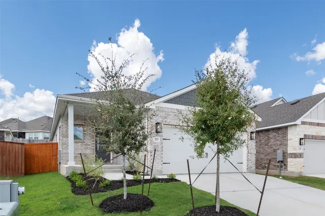 a view of a house with a yard and a fountain