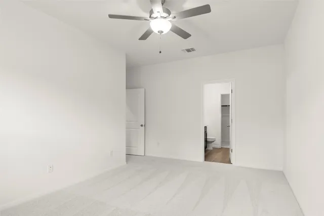 a view of a room with a ceiling fan and a ceiling fan