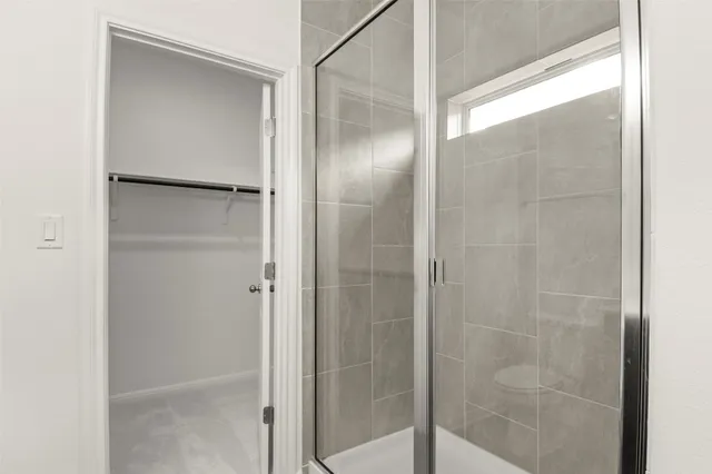 a bathroom with a glass shower door