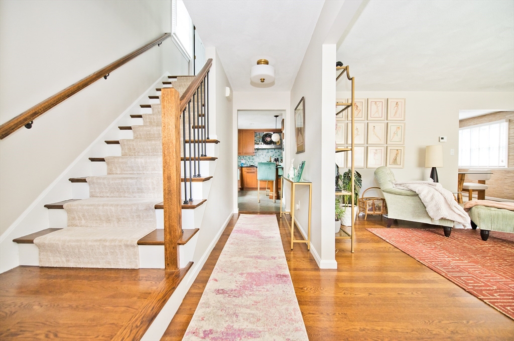 16 Warren Avenue Newton, MA 02465 - Photo 3 of 42 a view of staircase with lots of frames on wall and a large window