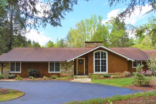 85 Forest Road Asheville, NC 28803 - Photo 2 of 39 a front view of a house with a garden and porch