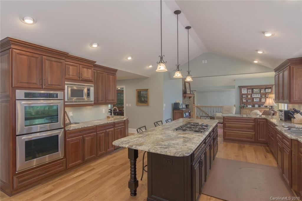85 Forest Road Asheville, NC 28803 - Photo 11 of 39 a kitchen with stainless steel appliances granite countertop a kitchen island a stove and a sink