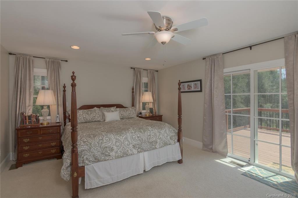 85 Forest Road Asheville, NC 28803 - Photo 16 of 39 a bedroom with a bed and a lamp with window