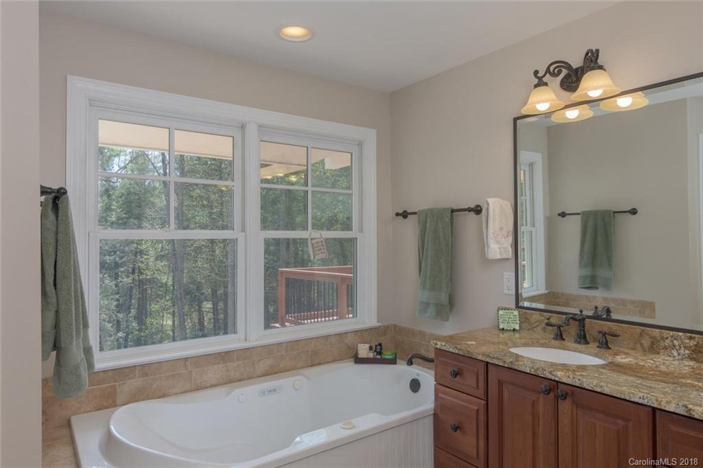 85 Forest Road Asheville, NC 28803 - Photo 17 of 39 a bathroom with a granite countertop sink and a mirror