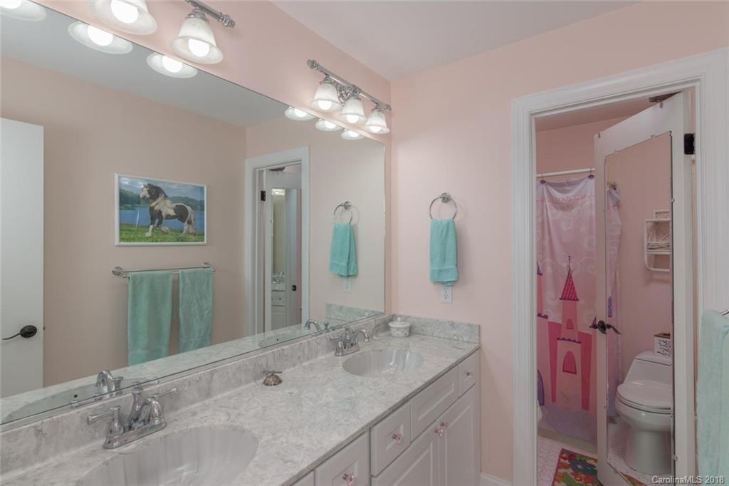 85 Forest Road Asheville, NC 28803 - Photo 20 of 39 a bathroom with a granite countertop sink toilet and shower