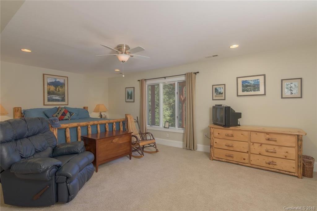 85 Forest Road Asheville, NC 28803 - Photo 25 of 39 a bedroom with furniture and a couch