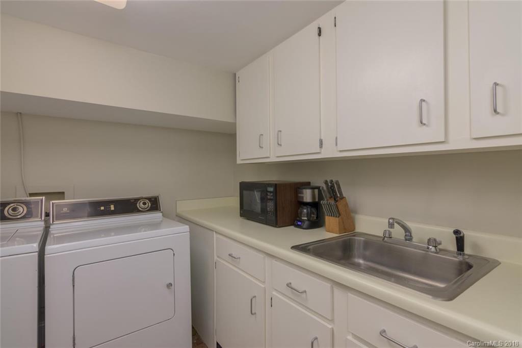 85 Forest Road Asheville, NC 28803 - Photo 26 of 39 a kitchen with cabinets appliances a sink and dishwasher