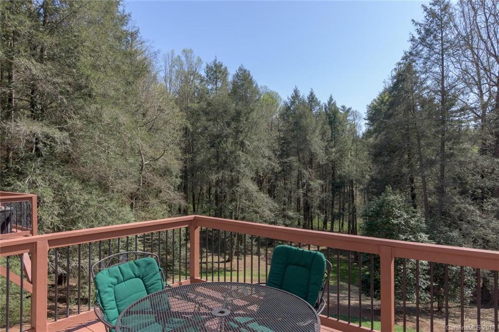 85 Forest Road Asheville, NC 28803 - Photo 33 of 39 a view of balcony with furniture and trees