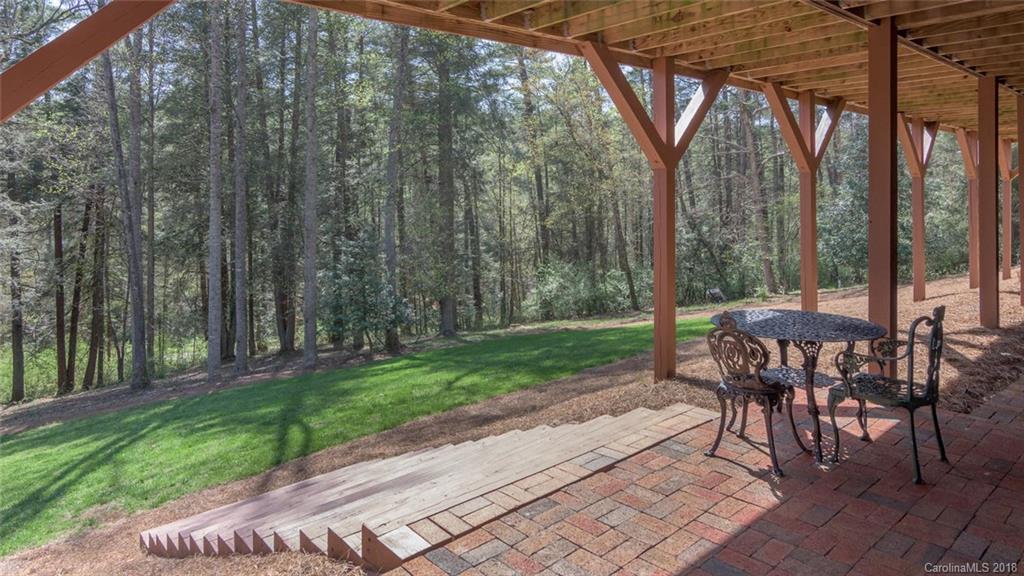 85 Forest Road Asheville, NC 28803 - Photo 34 of 39 a view of a patio with a table chairs and a backyard