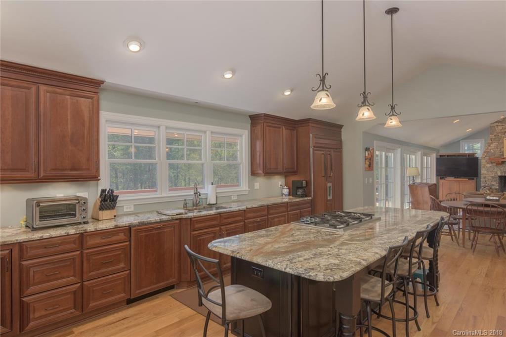 85 Forest Road Asheville, NC 28803 - Photo 10 of 39 a kitchen with center island table and chairs in it