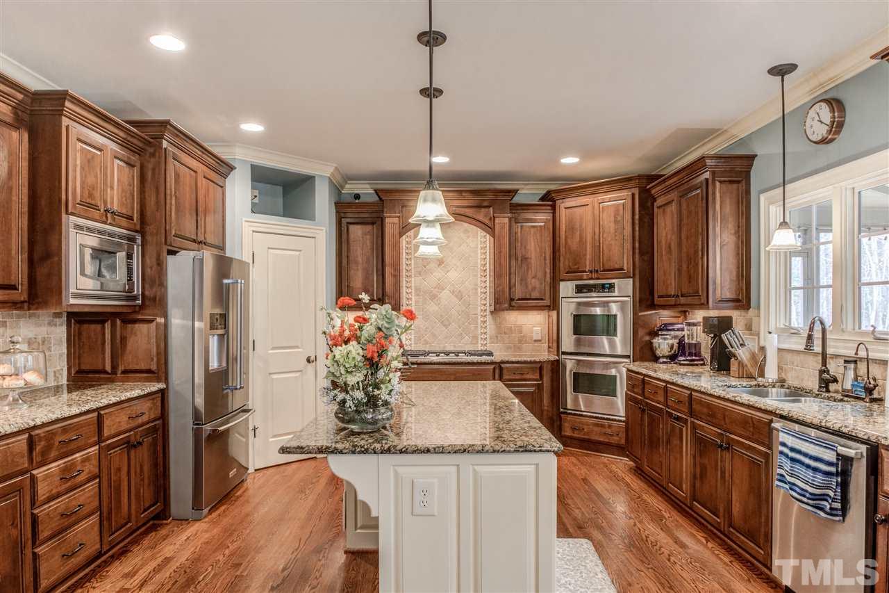 12228 Peed Road Raleigh, NC 27614 - Photo 11 of 30 a kitchen with stainless steel appliances granite countertop a sink stove and refrigerator