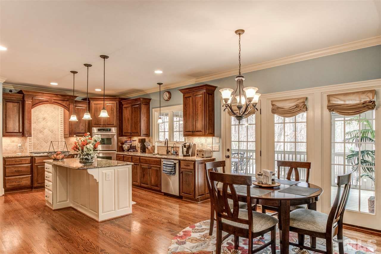 12228 Peed Road Raleigh, NC 27614 - Photo 12 of 30 a kitchen with lots of counter top space and dining table