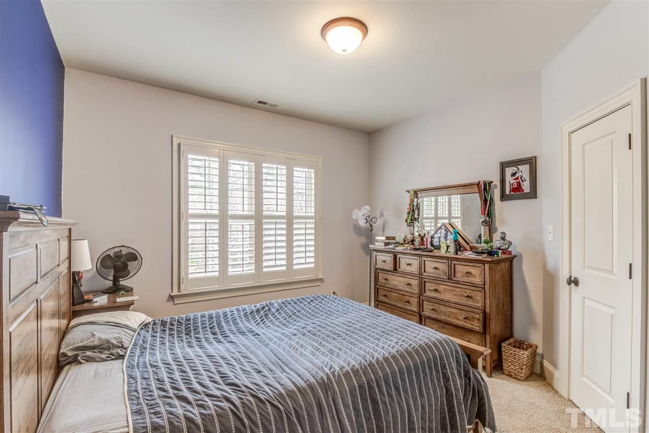 12228 Peed Road Raleigh, NC 27614 - Photo 22 of 30 a bedroom with a bed and wooden floor