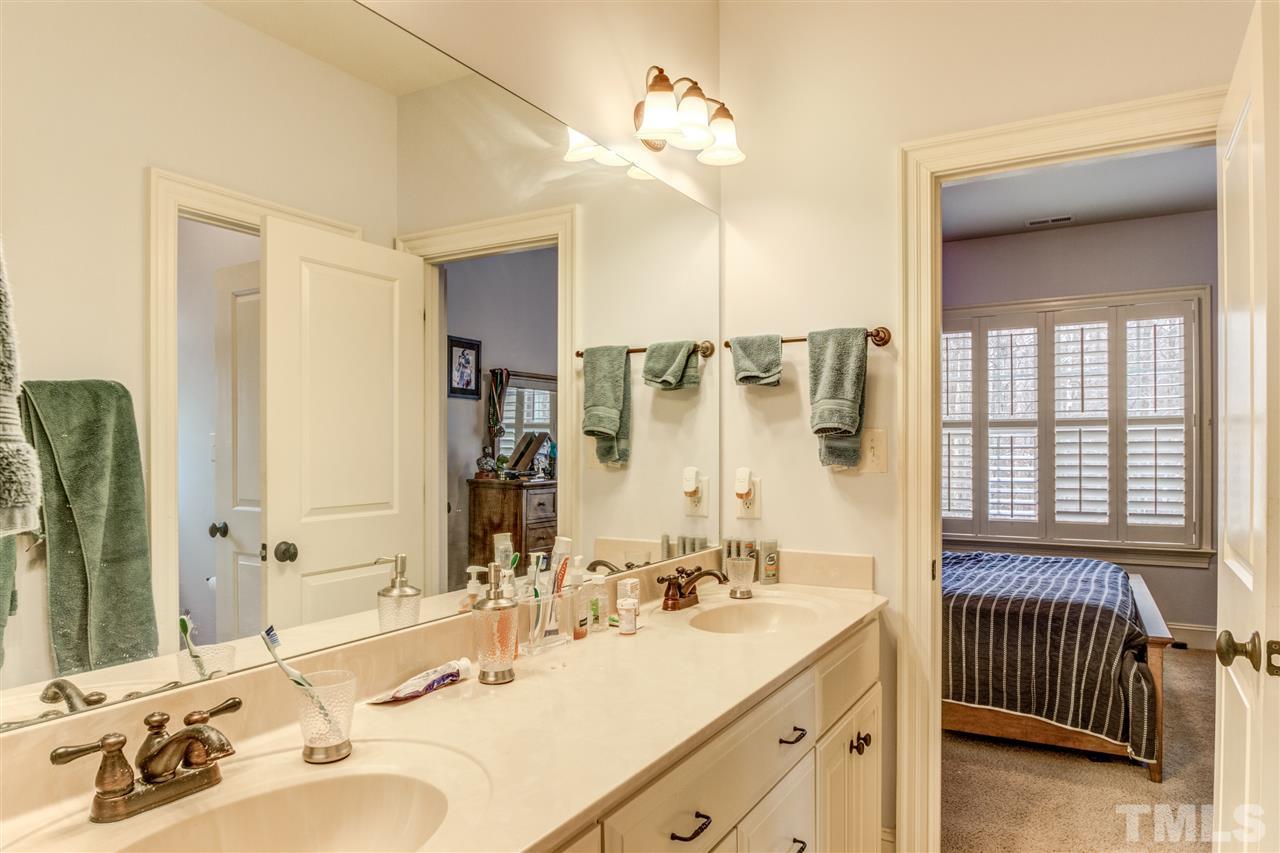 12228 Peed Road Raleigh, NC 27614 - Photo 23 of 30 a bathroom with a double vanity sink and a mirror