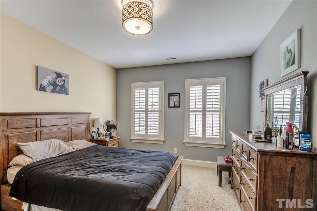 12228 Peed Road Raleigh, NC 27614 - Photo 24 of 30 a bed sitting in a bedroom next to a window