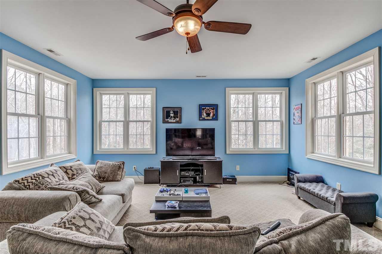 12228 Peed Road Raleigh, NC 27614 - Photo 25 of 30 a living room with furniture large window and a fireplace