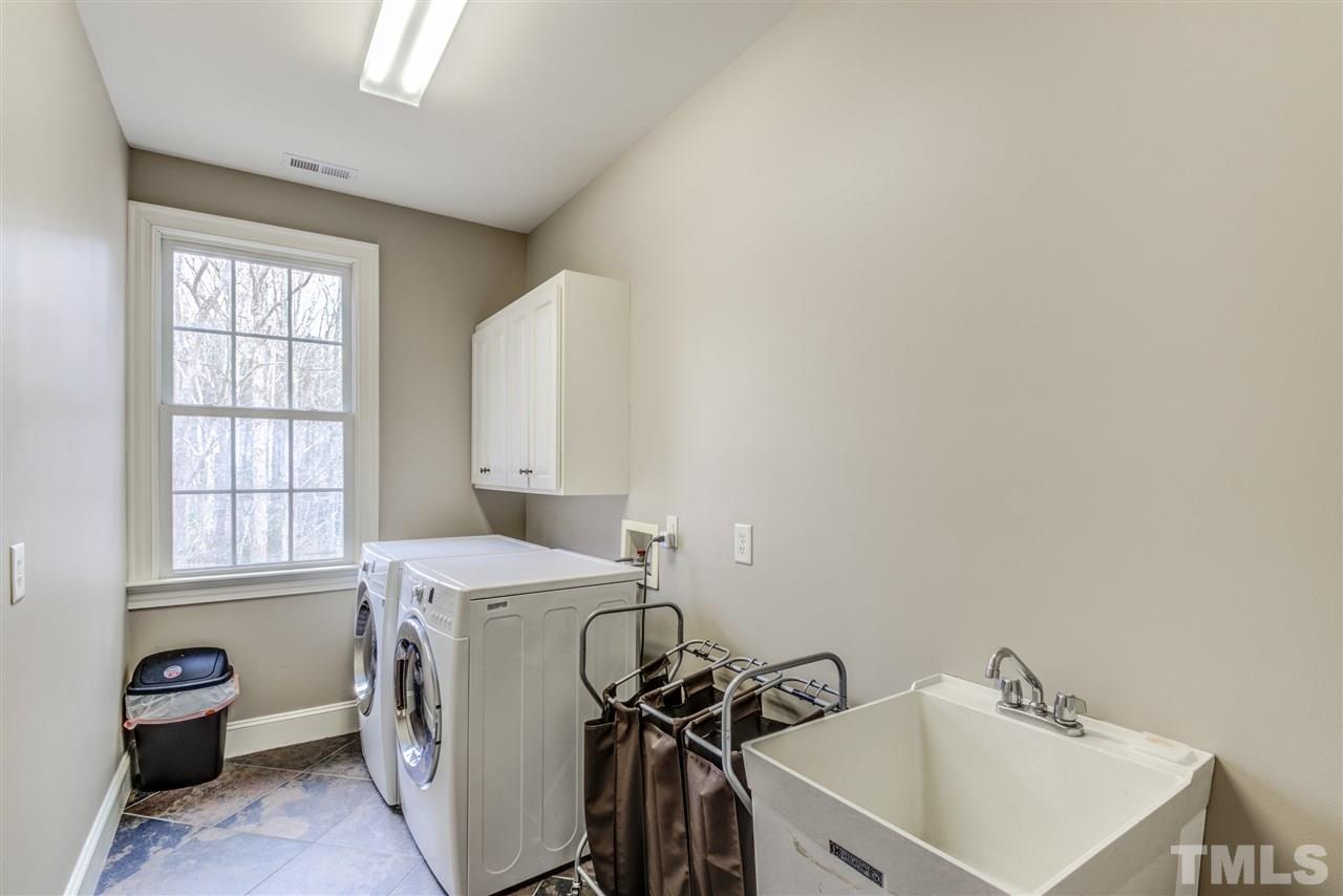 12228 Peed Road Raleigh, NC 27614 - Photo 26 of 30 a utility room with a sink dryer and washer