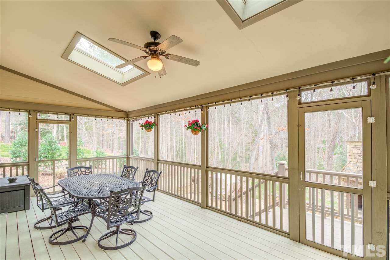 12228 Peed Road Raleigh, NC 27614 - Photo 28 of 30 a view of a dining room with furniture wooden floor and chandelier