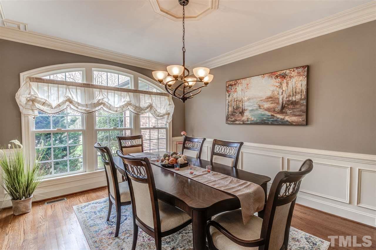 12228 Peed Road Raleigh, NC 27614 - Photo 8 of 30 a dining room with furniture wooden floor and a chandelier