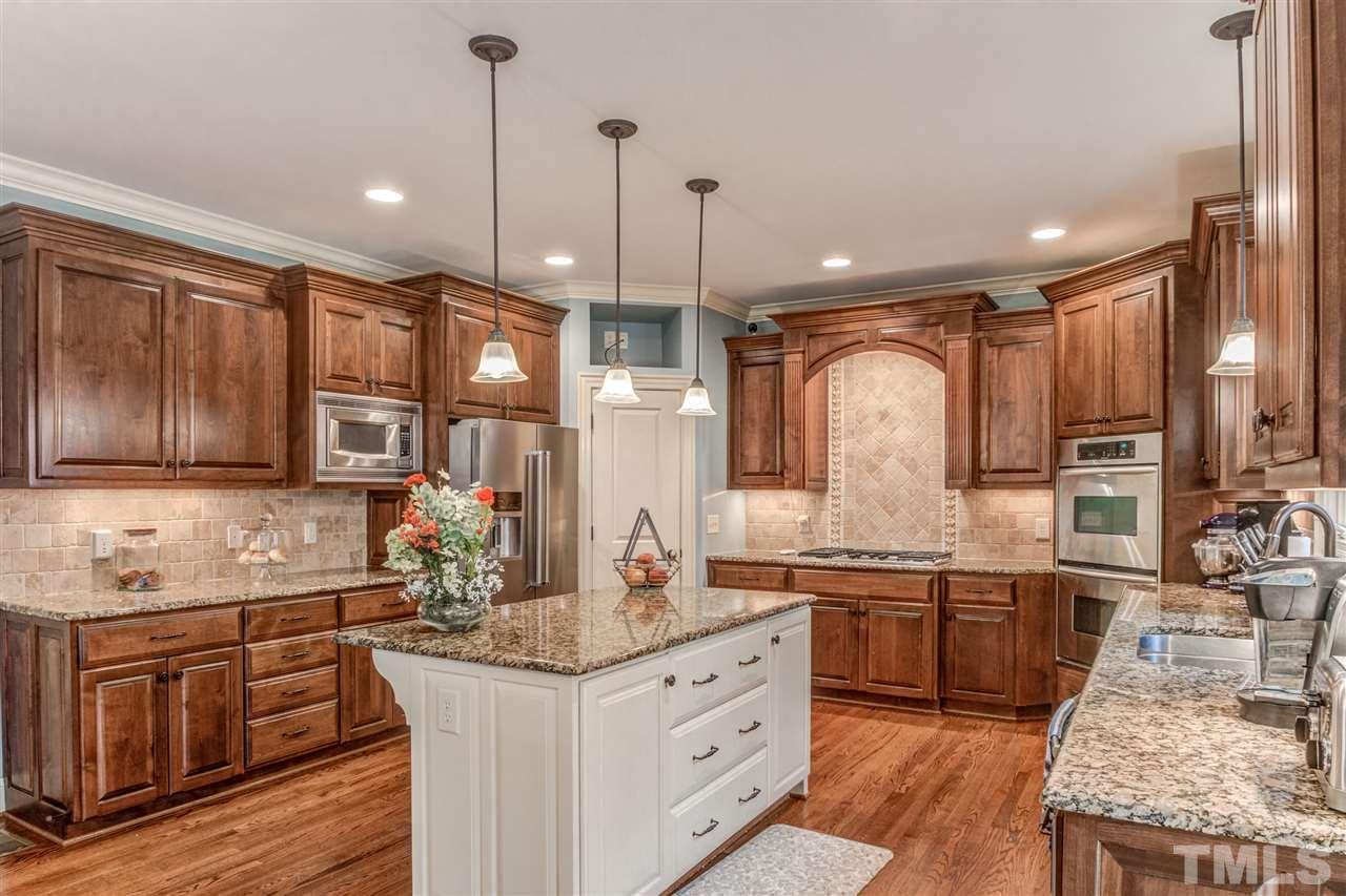 12228 Peed Road Raleigh, NC 27614 - Photo 10 of 30 a kitchen with granite countertop a sink stove and cabinets