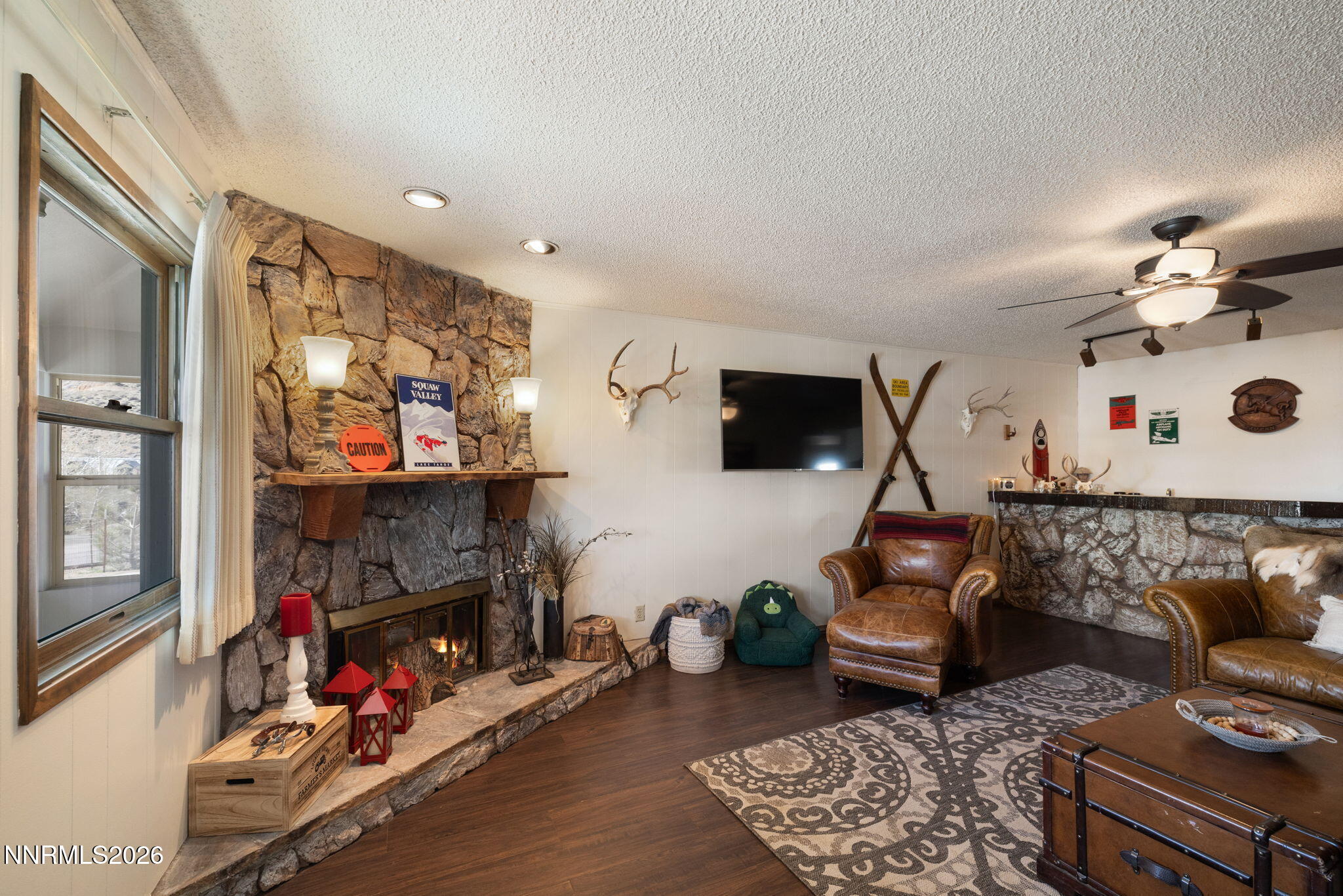 99 Toll Road Virginia City, NV 89440 - Photo 13 of 44 a living room with furniture a flat screen tv and a fireplace