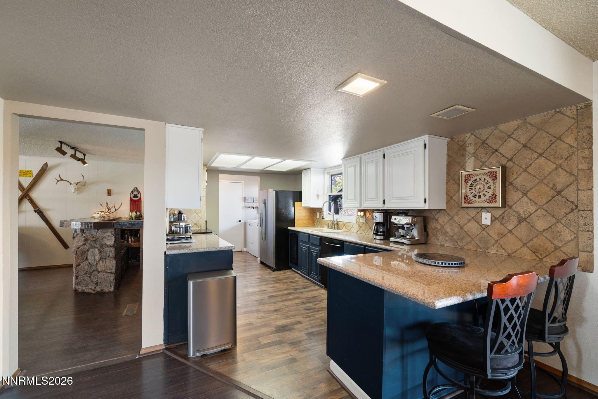 99 Toll Road Virginia City, NV 89440 - Photo 17 of 44 a kitchen with stainless steel appliances granite countertop a table chairs and a refrigerator