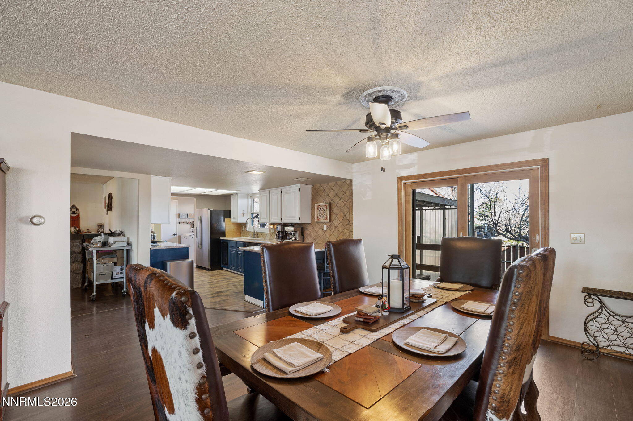 99 Toll Road Virginia City, NV 89440 - Photo 21 of 44 a view of a dining room with furniture a chandelier and wooden floor
