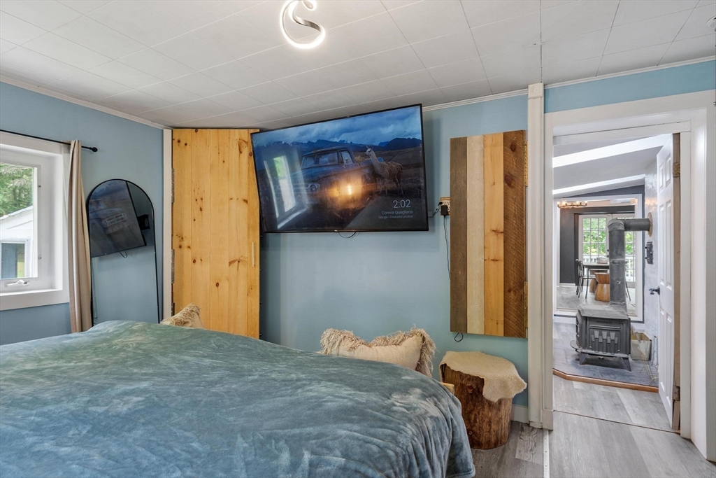 144 Bailey Road Holden, MA 01520 - Photo 15 of 42 a bedroom with a bed and a flat tv screen