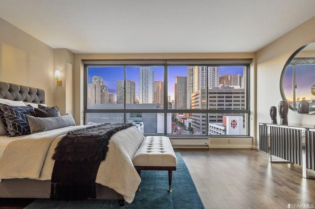 a bedroom with a large bed and potted plants