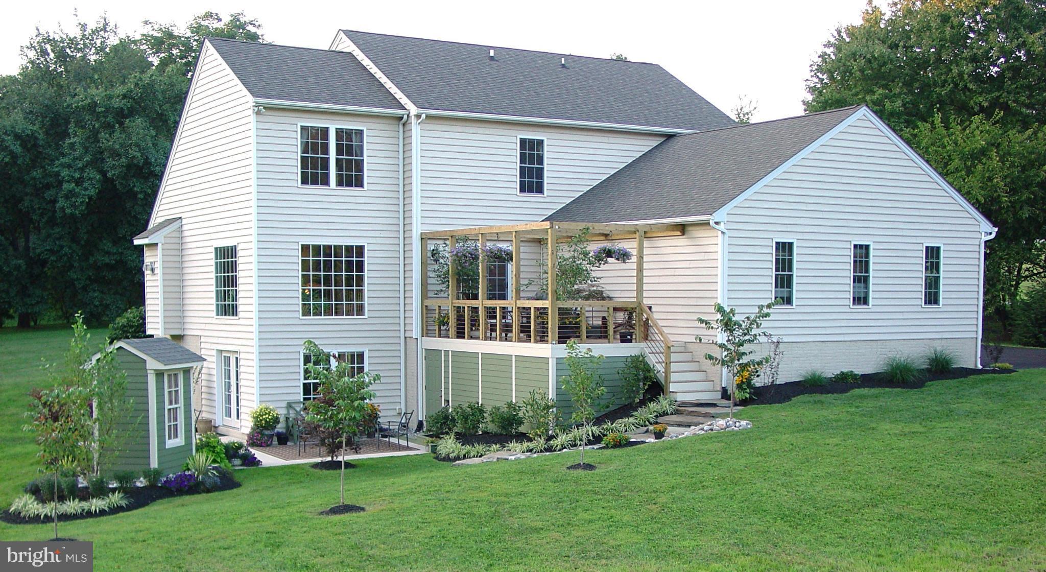 2705 Garrett Road White Hall, MD 21161 - Photo 11 of 30 a front view of a house with a garden and plants