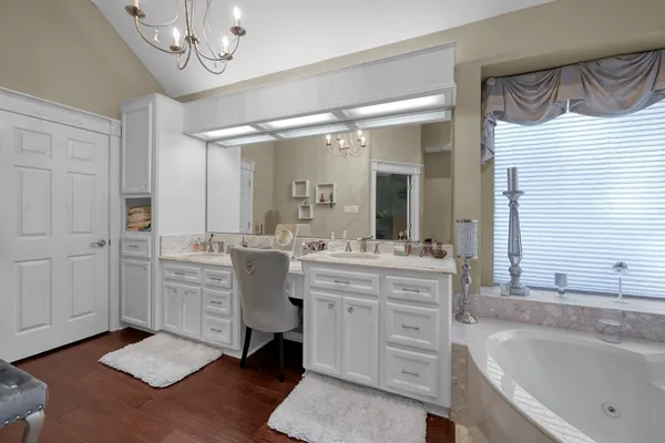 a bathroom with a tub a sink and a shower