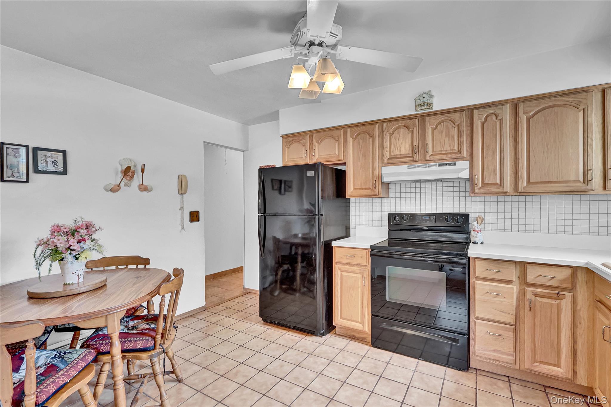 70 Blue Point Road Selden, NY 11784 - Photo 11 of 27 a kitchen with stainless steel appliances a stove a refrigerator and a dining table