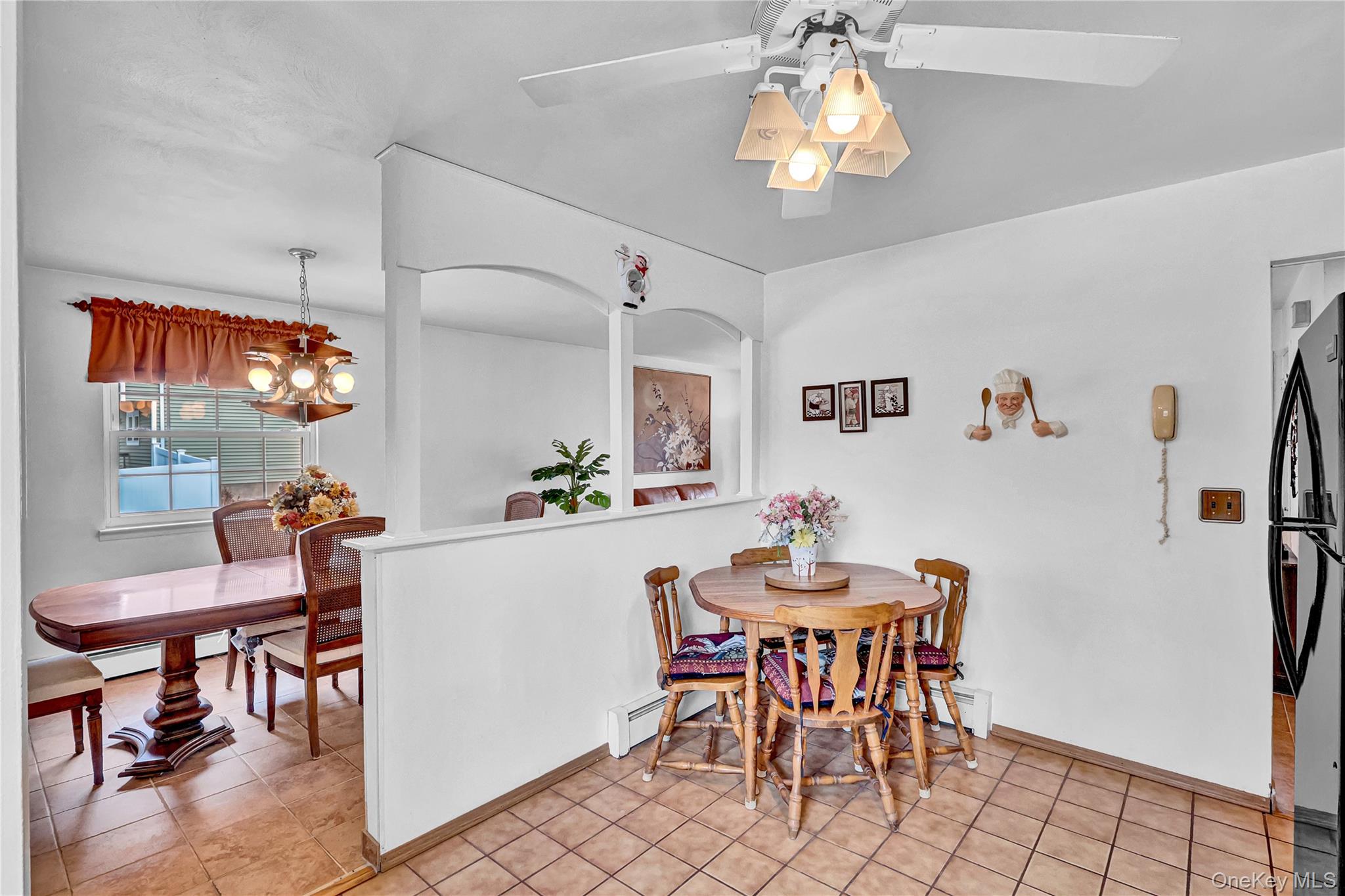 70 Blue Point Road Selden, NY 11784 - Photo 13 of 27 a dining room with furniture a chandelier and wooden floor