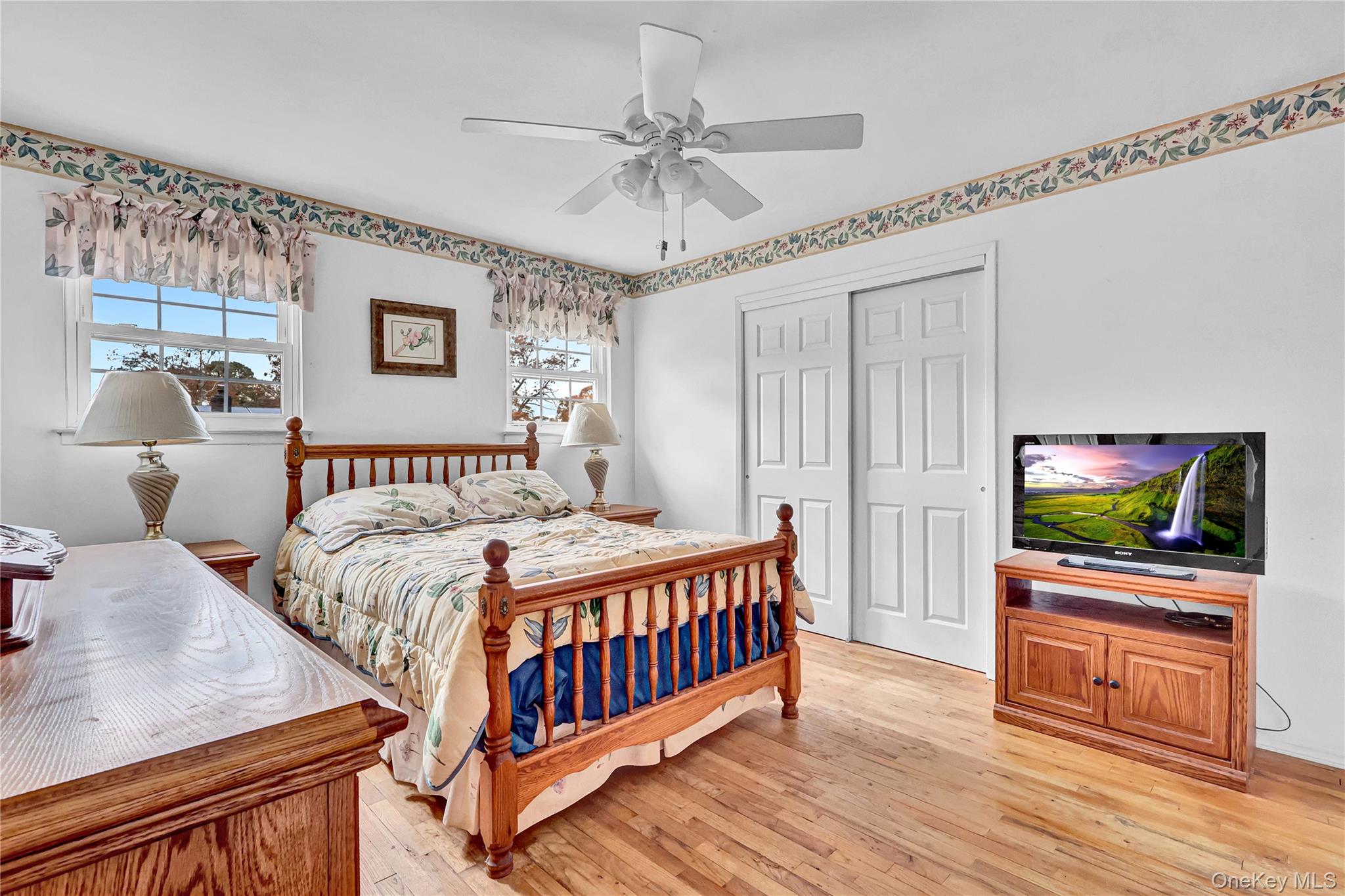 70 Blue Point Road Selden, NY 11784 - Photo 15 of 27 a bedroom with furniture and a flat screen tv