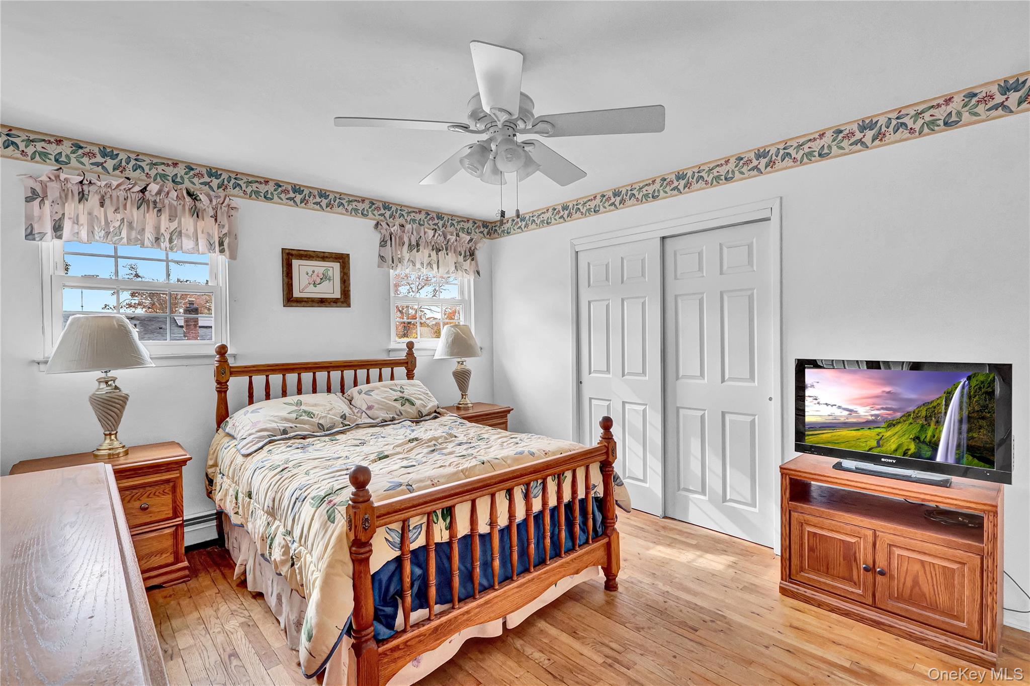 70 Blue Point Road Selden, NY 11784 - Photo 16 of 27 a bedroom with a bed and a flat screen tv