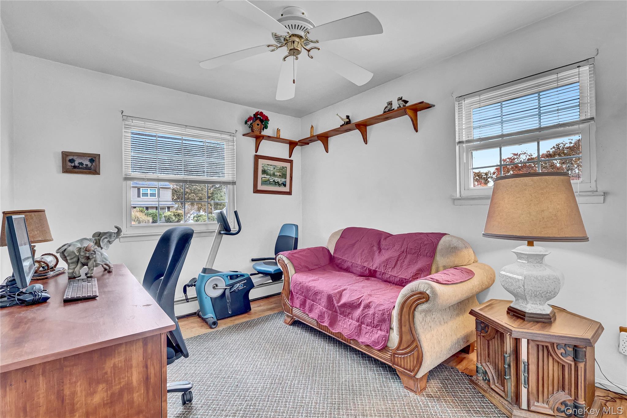 70 Blue Point Road Selden, NY 11784 - Photo 17 of 27 a living room with furniture and a window