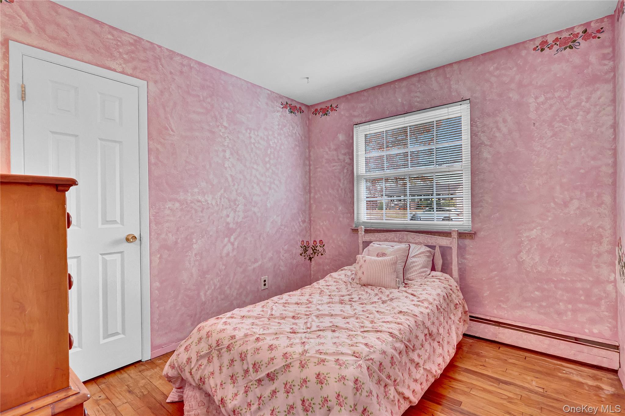 70 Blue Point Road Selden, NY 11784 - Photo 18 of 27 a bedroom with a bed and wooden floor