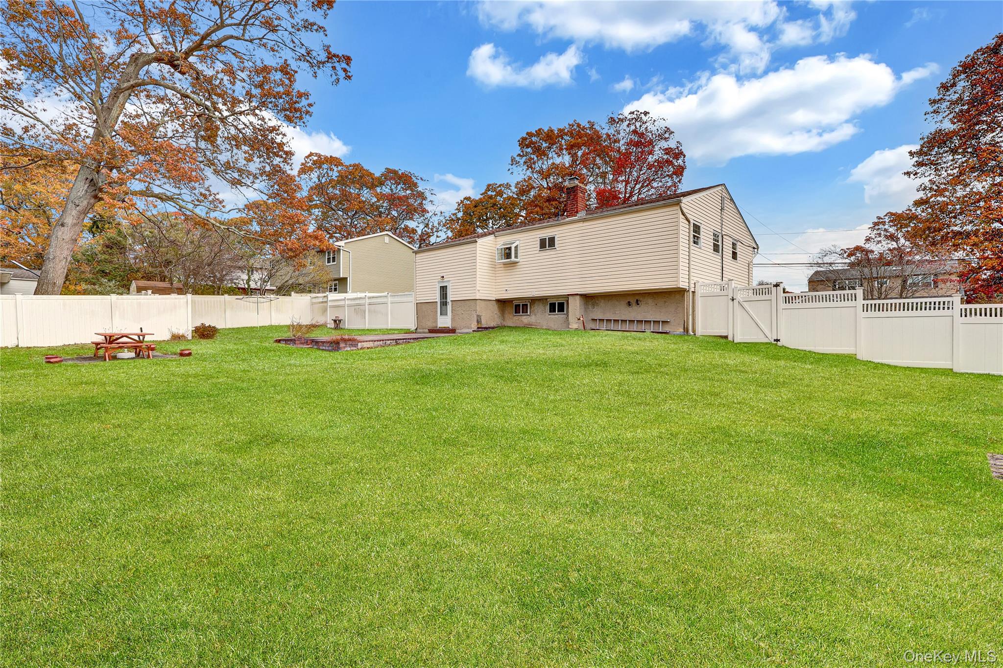 70 Blue Point Road Selden, NY 11784 - Photo 23 of 27 a view of a house with a big yard and large trees