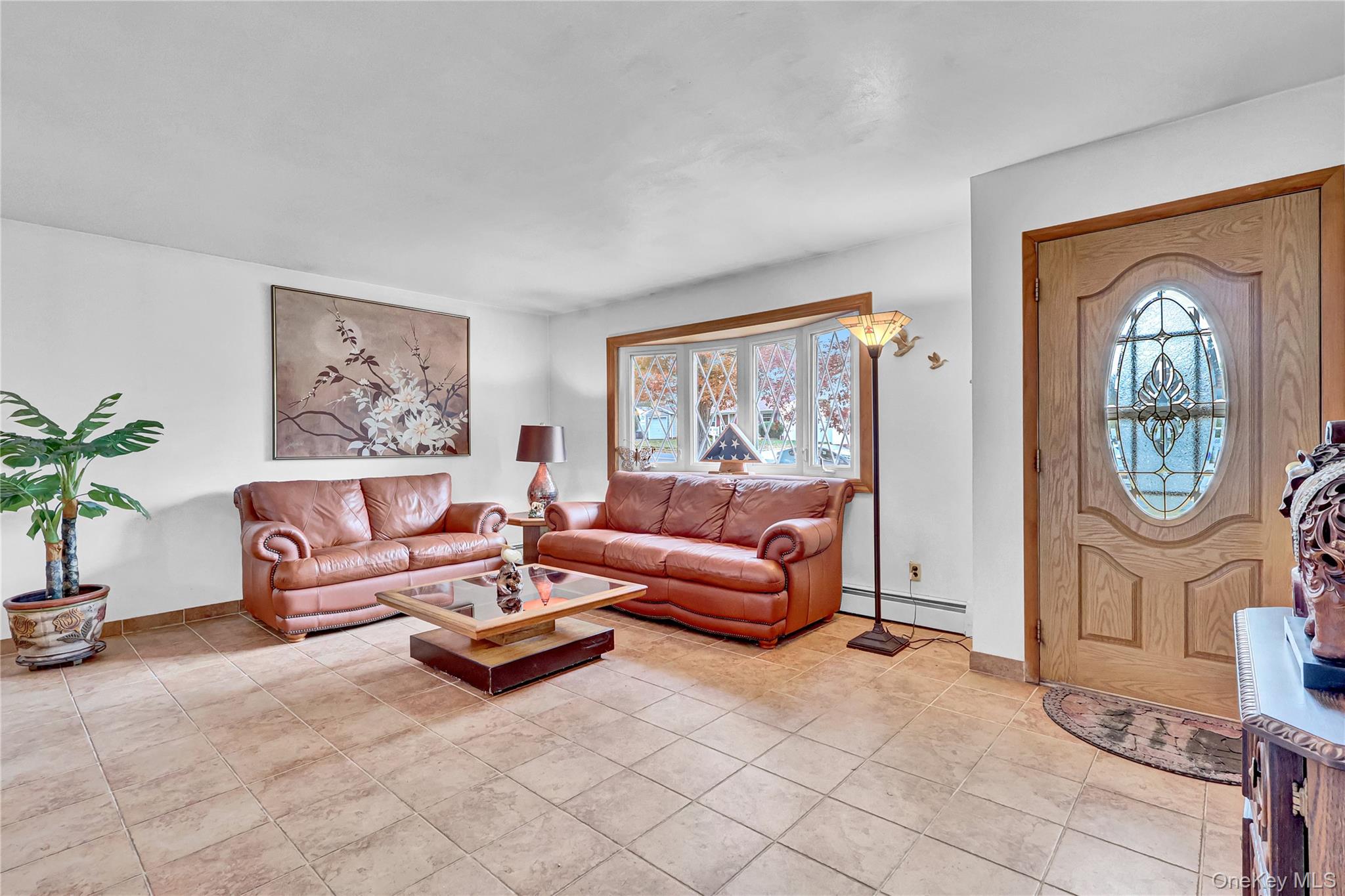 70 Blue Point Road Selden, NY 11784 - Photo 4 of 27 a living room with furniture and a large window