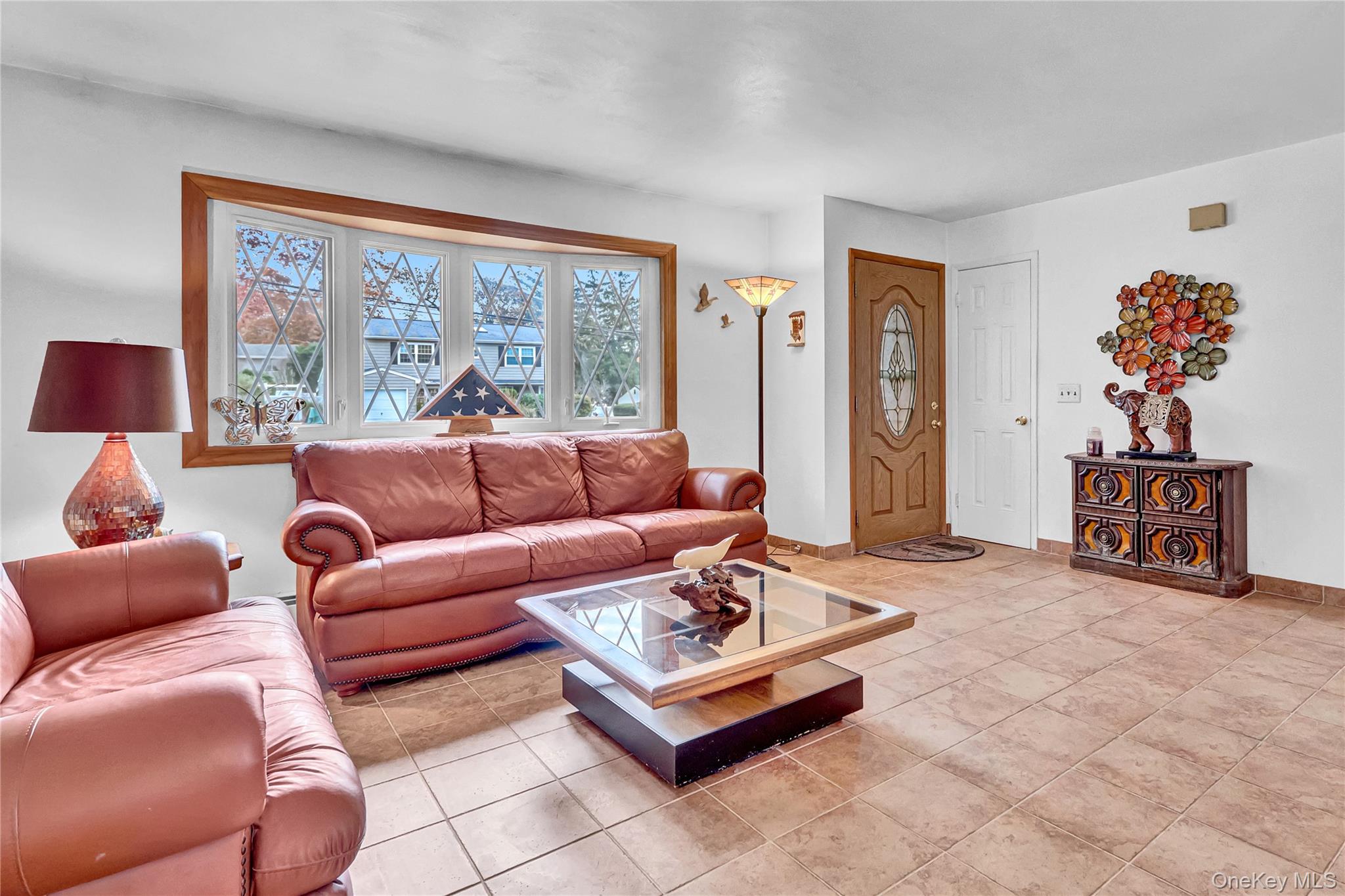 70 Blue Point Road Selden, NY 11784 - Photo 5 of 27 a living room with furniture and a large window