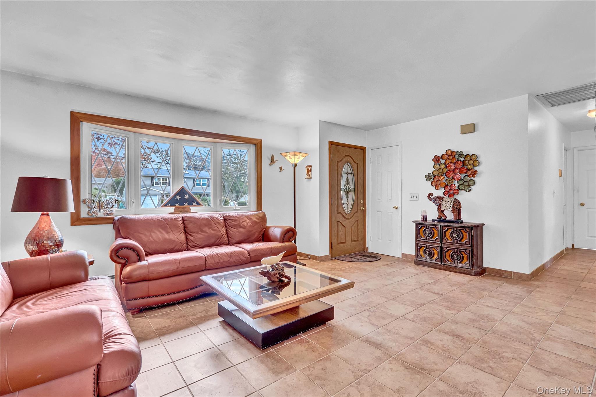70 Blue Point Road Selden, NY 11784 - Photo 6 of 27 a living room with furniture and a large window
