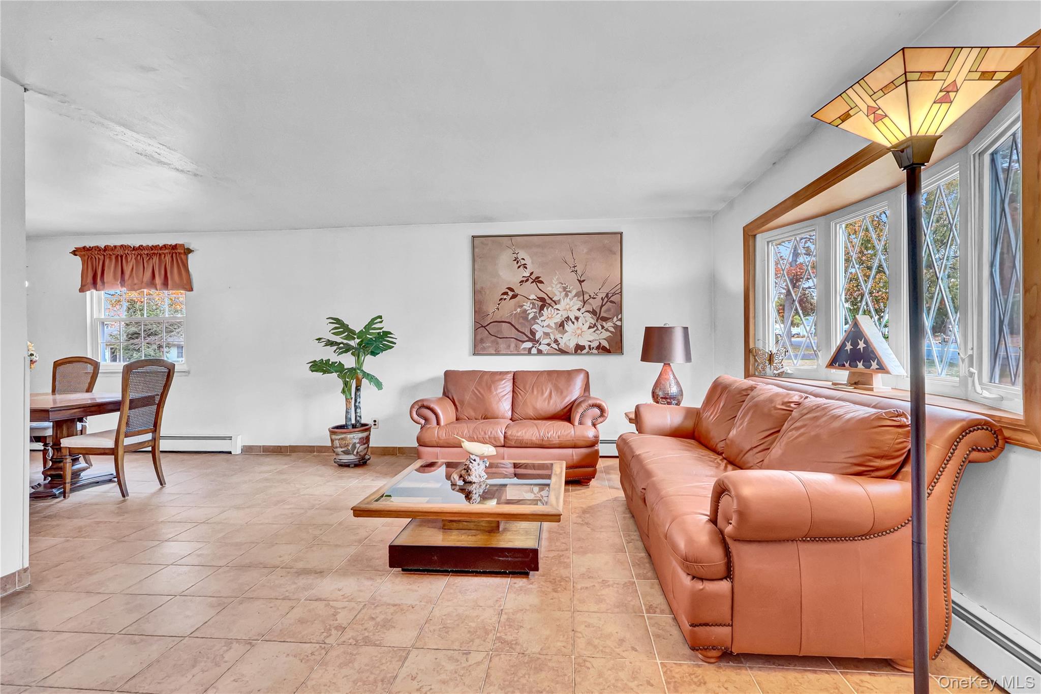 70 Blue Point Road Selden, NY 11784 - Photo 8 of 27 a living room with furniture a rug and a large window
