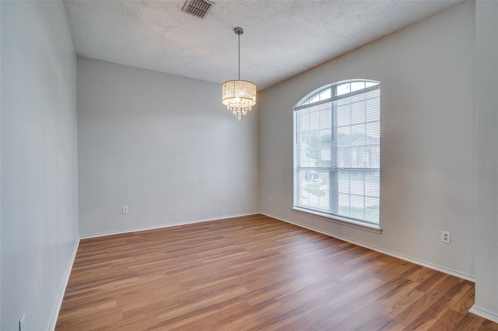 2401 Redfield Drive Mesquite, TX 75181 - Photo 10 of 25 wooden floor in an empty room with a window
