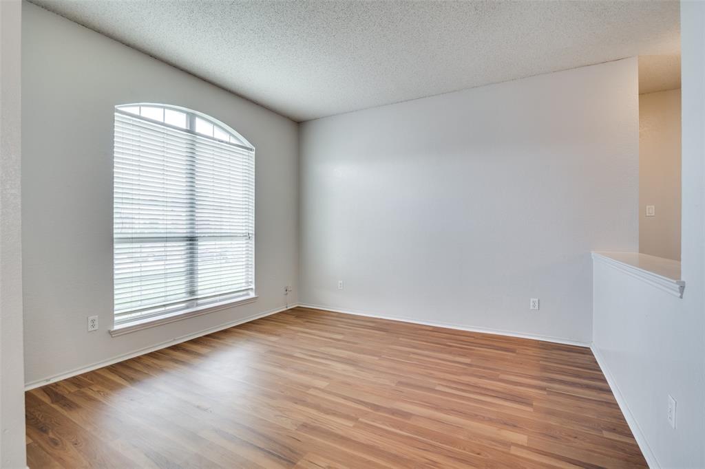 2401 Redfield Drive Mesquite, TX 75181 - Photo 11 of 25 an empty room with wooden floor and windows