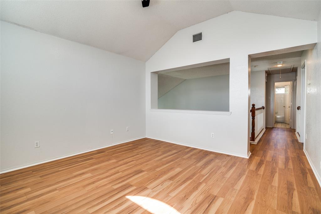 2401 Redfield Drive Mesquite, TX 75181 - Photo 16 of 25 an empty room with wooden floor and a ceiling fan