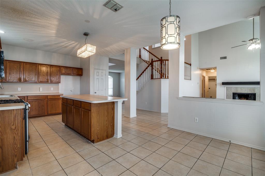 2401 Redfield Drive Mesquite, TX 75181 - Photo 25 of 25 a kitchen with granite countertop a refrigerator a stove and a sink