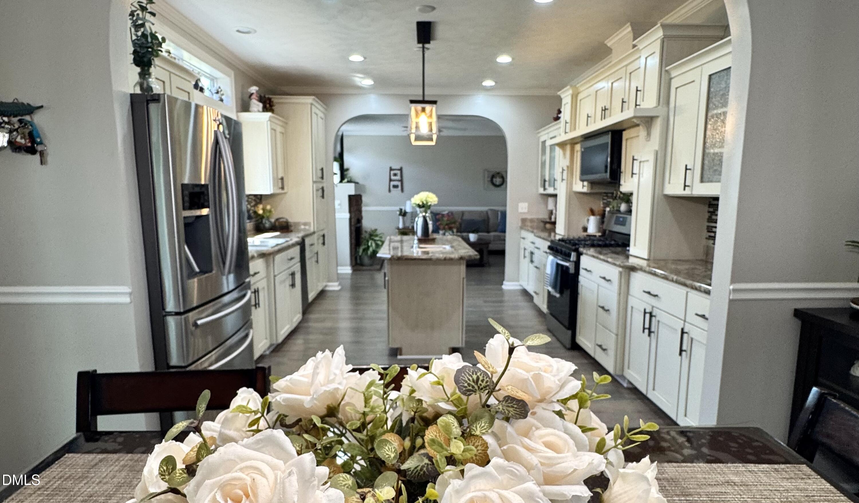 640 Tart Town Road Dunn, NC 28334 - Photo 24 of 71 a hallway with white cabinets and chandelier